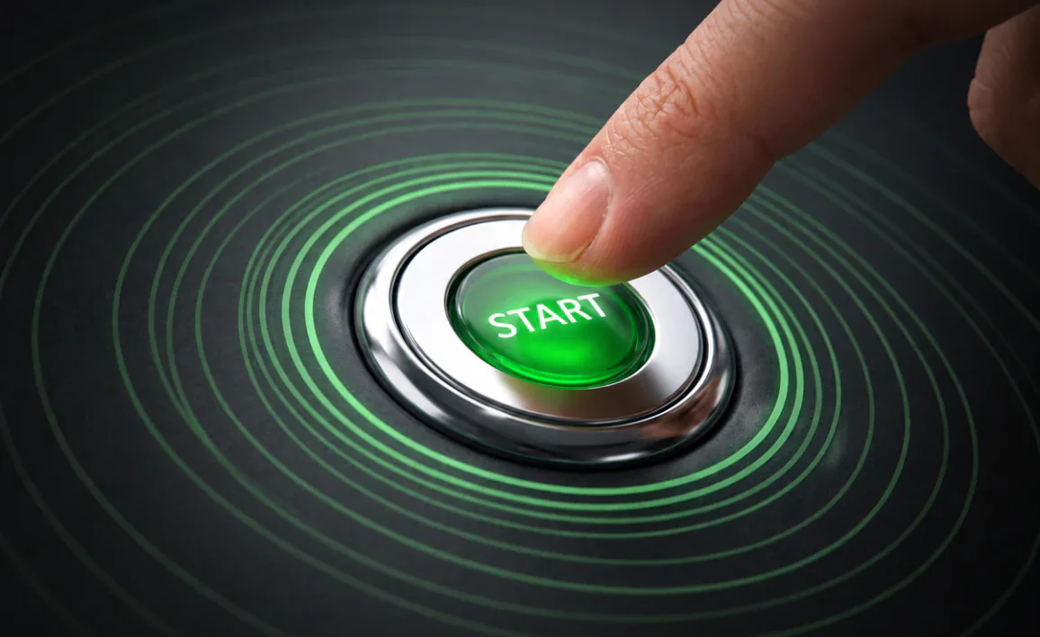 Close-up of a finger pressing a glowing green "START" button, symbolizing Omnistrate's new frictionless onboarding and one-click control plane generation.